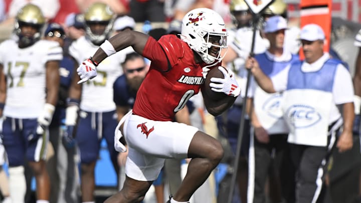 Sep 21, 2024; Louisville, Kentucky, USA;  Louisville Cardinals wide receiver Chris Bell (0) runs the ball against the Georgia Tech Yellow Jackets during the first half at L&N Federal Credit Union Stadium. Mandatory Credit: Jamie Rhodes-Imagn Images