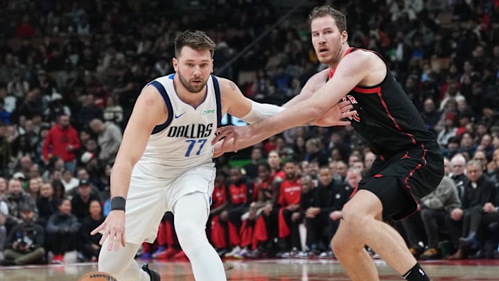 Dec 7, 2024; Toronto, Ontario, CAN; Dallas Mavericks guard Luka Doncic (77) controls the ball against Toronto Raptors center Jakob Poeltl (19) during the first quarter at Scotiabank Arena. Mandatory Credit: Nick Turchiaro-Imagn Images