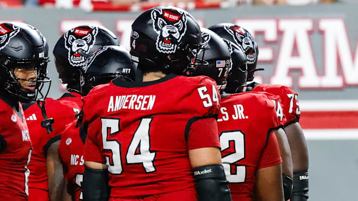 Sep 27, 2025; Raleigh, North Carolina, USA; North Carolina State Wolfpack huddle during the first half of the game against Virginia Tech Hokies at Carter-Finley Stadium. Mandatory Credit: Jaylynn Nash-Imagn Images Sep 27, 2025; Raleigh, North Carolina, USA; North Carolina State Wolfpack huddle during the first half of the game against Virginia Tech Hokies at Carter-Finley Stadium. Mandatory Credit: Jaylynn Nash-Imagn Images