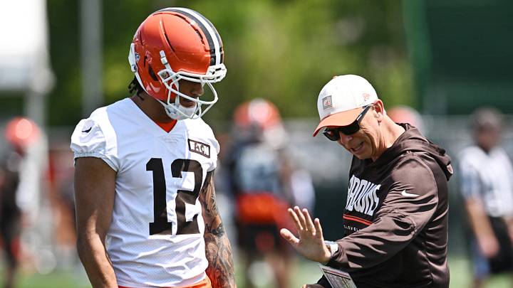 Cleveland Browns head coach Todd Monken talks to wide receiver Denzel Boston