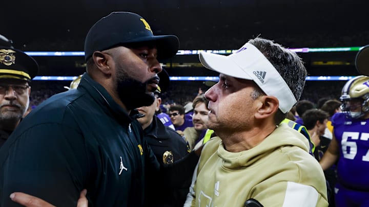 Oct 5, 2024; Seattle, Washington, USA; Michigan Wolverines head coach Sherrone Moore, left, shakes hands with Washington Huskies head coach Jedd Fisch, right, following a Washington victory at Alaska Airlines Field at Husky Stadium. Mandatory Credit: Joe Nicholson-Imagn Images Oct 5, 2024; Seattle, Washington, USA; Michigan Wolverines head coach Sherrone Moore, left, shakes hands with Washington Huskies head coach Jedd Fisch, right, following a Washington victory at Alaska Airlines Field at Husky Stadium. Mandatory Credit: Joe Nicholson-Imagn Images