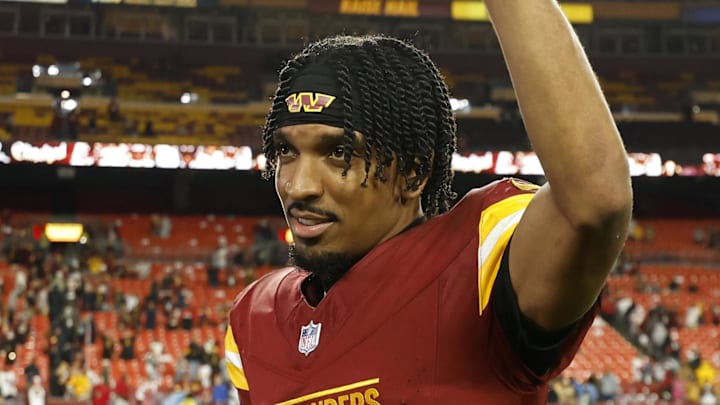 Washington Commanders quarterback Jayden Daniels waves to the crowd after a win.