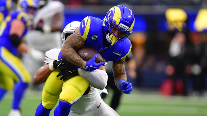 Jan 4, 2026; Inglewood, California, USA;  Los Angeles Rams running back Kyren Williams (23) carries the ball as Arizona Cardinals linebacker Cody Simon (50) defends during the first half at SoFi Stadium. Mandatory Credit: Gary A. Vasquez-Imagn Images
