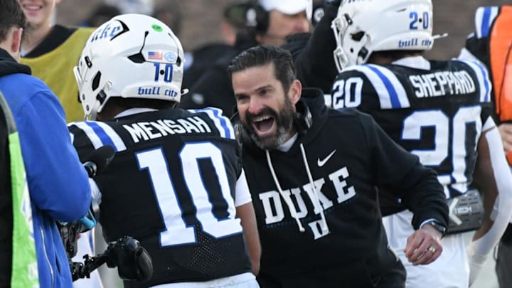 Nov 29, 2025; Durham, North Carolina, USA; Duke Blue Devils head coach Manny Diaz celebrates Duke Blue Devils quarter back Darian Mensah's (10) touchdown against the Wake Forest Demon Deacons during the second quarter at Wallace Wade Stadium. Mandatory Credit: Zachary Taft-Imagn Images Nov 29, 2025; Durham, North Carolina, USA; Duke Blue Devils head coach Manny Diaz celebrates Duke Blue Devils quarter back Darian Mensah's (10) touchdown against the Wake Forest Demon Deacons during the second quarter at Wallace Wade Stadium. Mandatory Credit: Zachary Taft-Imagn Images