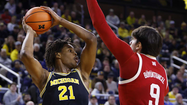 Michigan forward Morez Johnson Jr. is defended by Nebraska forward Berke Büyüktuncel.