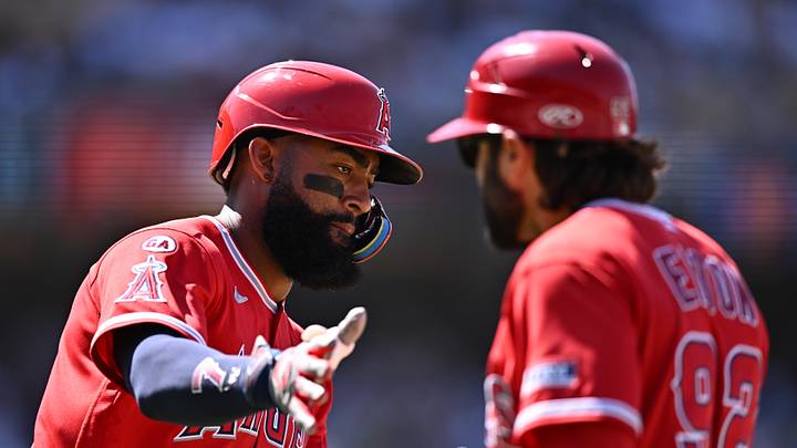 Jun 7, 2026; Los Angeles, California, USA;  Los Angeles Angels right fielder Jo Adell (7) slaps the hand of first base/outfield coach Adam Eaton (92) after hitting a two-run home run against the Los Angeles Dodgers during the seventh inning at Dodger Stadium. Mandatory Credit: William Liang-Imagn Images
