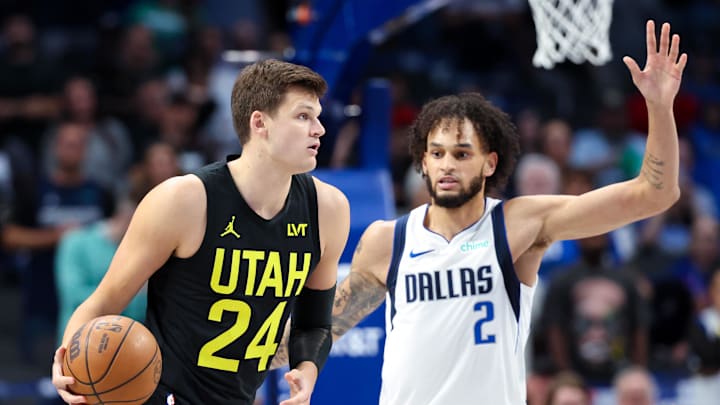 Oct 10, 2024; Dallas, Texas, USA;  Utah Jazz center Walker Kessler (24) dribbles as Dallas Mavericks center Dereck Lively II (2) defends during the first quarter at American Airlines Center. Mandatory Credit: Kevin Jairaj-Imagn Images