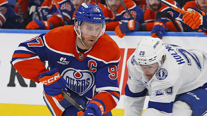 Mar 21, 2026; Edmonton, Alberta, CAN; Edmonton Oilers forward Connor McDavid (97) carries the puck past Tampa Bay Lightning forward Pontus Holmberg (29) during the third period at Rogers Place. Mandatory Credit: Perry Nelson-Imagn Images