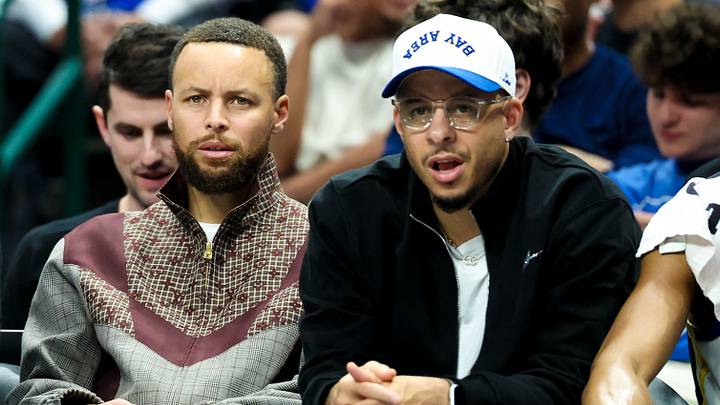 Dallas, Texas, USA;  Golden State Warriors guard Stephen Curry (left) sits with Golden State Warriors guard Seth Curry (right) during the first half against the Dallas Mavericks at American Airlines Center. Mandatory Credit: Kevin Jairaj-Imagn Images