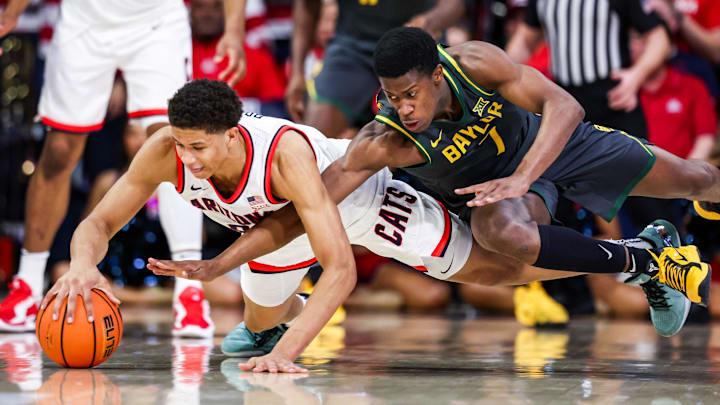 Arizona Wildcats forward Carter Bryant (9) and Baylor Bears guard VJ Edgecombe (7) dive for a loose ball. Arizona Wildcats forward Carter Bryant (9) and Baylor Bears guard VJ Edgecombe (7) dive for a loose ball.