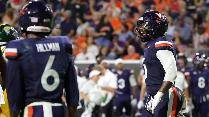 Sep 11, 2026; Charlottesville, Virginia, USA;  Virginia Cavaliers linebacker Kam Robinson (5) and safety Brandyn Hillman (6) react to a play during the second quarter against Norfolk State.  Mandatory Credit: Amber Searls-Imagn Images