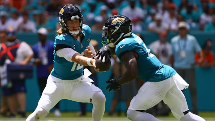 Sep 8, 2024; Miami Gardens, Florida, USA; Jacksonville Jaguars quarterback Trevor Lawrence (16) fakes a handoff to running back Tank Bigsby (4) during the first quarter at Hard Rock Stadium. Mandatory Credit: Sam Navarro-Imagn Images