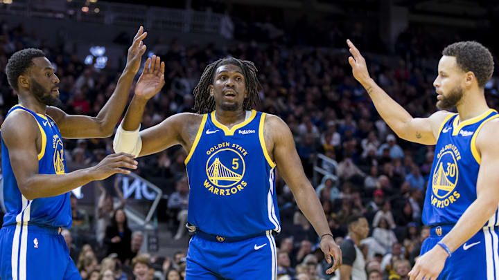 Jan 4, 2024; San Francisco, California, USA; Golden State Warriors forward Andrew Wiggins (22) and guard Kevon Looney (5) and guard Stephen Curry (30) react after drawing a foul against the Denver Nuggets during the first half at Chase Center. Mandatory Credit: John Hefti-Imagn Images