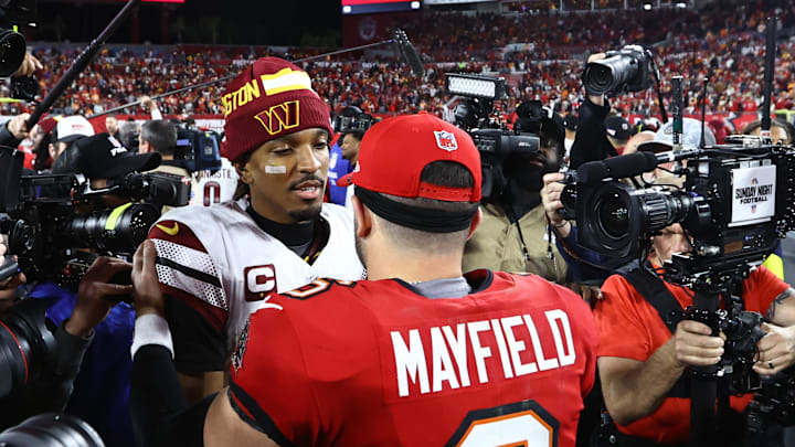 Jan 12, 2025; Tampa, Florida, USA; Washington Commanders quarterback Jayden Daniels (5) greets Tampa Bay Buccaneers quarterback Baker Mayfield (6) after winning a NFC wild card playoff at Raymond James Stadium. Mandatory Credit: Kim Klement Neitzel-Imagn Images