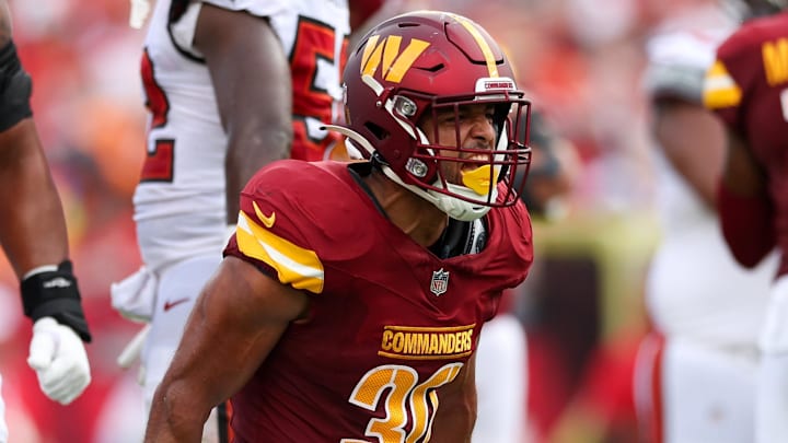 Sep 8, 2024; Tampa, Florida, USA; Washington Commanders running back Austin Ekeler (30) reacts after a run against the Tampa Bay Buccaneers in the second quarter at Raymond James Stadium. Mandatory Credit: Nathan Ray Seebeck-Imagn Images