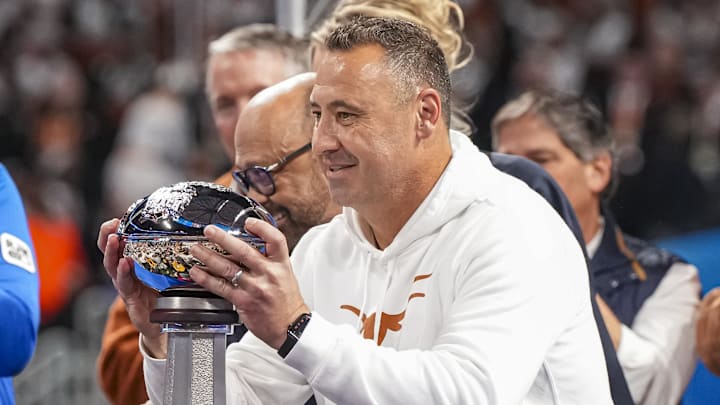 Texas Longhorns coach Steve Sarkisian  lifts the trophy after defeating the Arizona State Sun Devils at Mercedes-Benz Stadium.