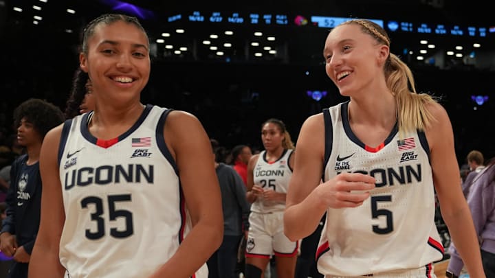 Dec 7, 2024; Brooklyn, New York, USA; Connecticut Huskies guard Azzi Fudd (35) and Connecticut Huskies guard Paige Bueckers (5) celebrate after the game against the Louisville Cardinals at Barclays Center. Mandatory Credit: Lucas Boland-Imagn Images