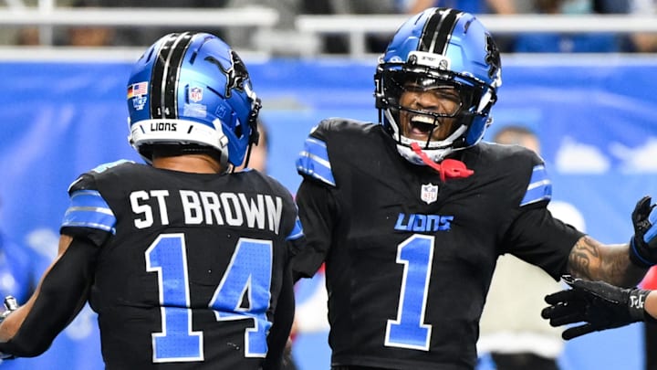Detroit Lions wide receiver Amon-Ra St. Brown (14) celebrates a touchdown with wide receiver Jameson Williams (1) 
