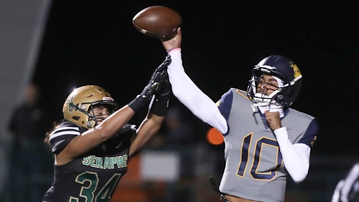 Warren quarterback Madden Iamaleava is under pressure by St. Bonaventure's Jacob Moraga as he fires a pass during the first quarter of the Seraphs' 24-21 win in the CIF-SS Division 3 championship game on Saturday, Nov. 25, 2023, at Ventura High's Larrabee Stadium.