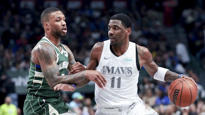 Dallas Mavericks guard Kyrie Irving (11) controls the ball as Milwaukee Bucks guard Damian Lillard (0) defends during the first half at American Airlines Center. Mandatory Credit: Kevin Jairaj-Imagn Images