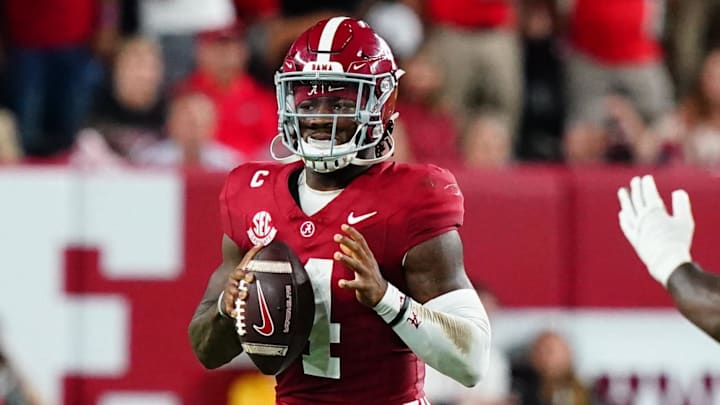 Sep 28, 2024; Tuscaloosa, Alabama, USA; Alabama Crimson Tide quarterback Jalen Milroe (4) drops back to pass against Georgia Bulldogs linebacker Raylen Wilson (5) during the first half at Bryant-Denny Stadium. Mandatory Credit: John David Mercer-Imagn Images Sep 28, 2024; Tuscaloosa, Alabama, USA; Alabama Crimson Tide quarterback Jalen Milroe (4) drops back to pass against Georgia Bulldogs linebacker Raylen Wilson (5) during the first half at Bryant-Denny Stadium. Mandatory Credit: John David Mercer-Imagn Images