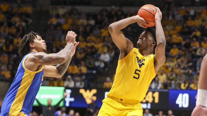 Nov 13, 2025; Morgantown, West Virginia, USA; West Virginia Mountaineers forward DJ Thomas (5) shoots during the second half against the Pittsburgh Panthers at WVU Coliseum. Mandatory Credit: Ben Queen-Imagn Images