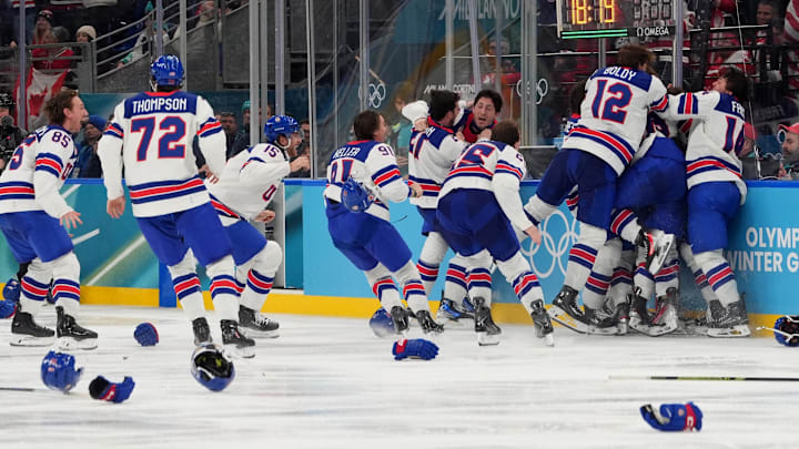 Feb 22, 2026; Milan, Italy; Jack Hughes (86) of the United States is congratulated by teammates after scoring the winning goal against Canada in the men's ice hockey gold medal game during the Milano Cortina 2026 Olympic Winter Games at Milano Santagiulia Ice Hockey Arena. Mandatory Credit: Amber Searls-Imagn Images Feb 22, 2026; Milan, Italy; Jack Hughes (86) of the United States is congratulated by teammates after scoring the winning goal against Canada in the men's ice hockey gold medal game during the Milano Cortina 2026 Olympic Winter Games at Milano Santagiulia Ice Hockey Arena. Mandatory Credit: Amber Searls-Imagn Images