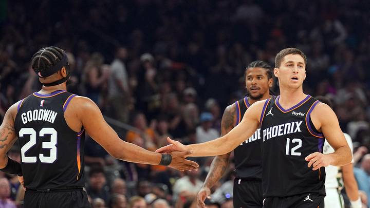 Mar 21, 2026; Phoenix, Arizona, USA; Phoenix Suns guard Jordan Goodwin (23) and Phoenix Suns guard Collin Gillespie (12) slap hands against the Milwaukee Bucks during the first half at Mortgage Matchup Center. Mandatory Credit: Joe Camporeale-Imagn Images
