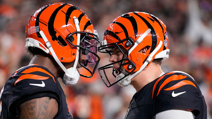 Bengals wide receiver Tee Higgins (5) and quarterback Joe Burrow (9) celebrate a touchdown in the fourth quarter against the Broncos at Paycor Stadium on Saturday, Dec. 28, 2024.