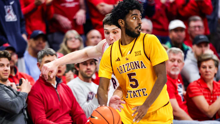 Jan 14, 2026; Tucson, Arizona, USA; Arizona Wildcats forward Ivan Kharchenkov (8) attempts to steal the ball from Arizona State Sun Devils guard Moe Odum (5) during the second half of the game at McKale Memorial Center. Mandatory Credit: Aryanna Frank-Imagn Images