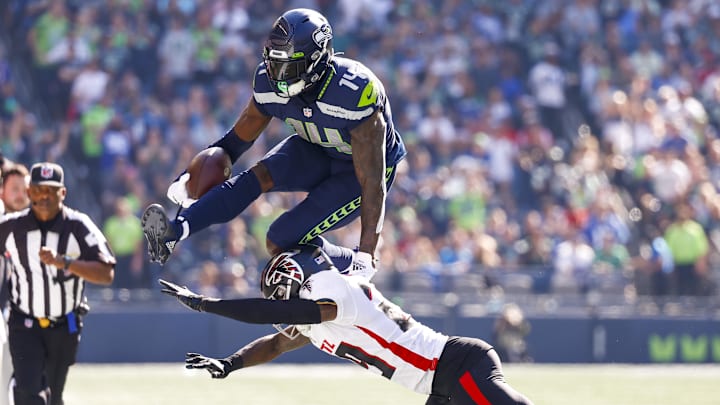Sep 25, 2022; Seattle, Washington, USA; Seattle Seahawks wide receiver DK Metcalf (14) jumps over a tackle attempt by Atlanta Falcons cornerback Casey Hayward (29) during the second quarter at Lumen Field.