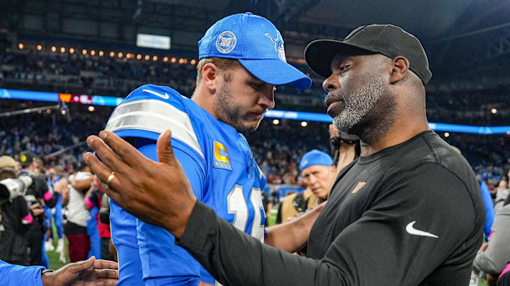 Detroit Lions quarterback Jared Goff shakes hands with Washington Commanders run game coordinator Anthony Lynn 