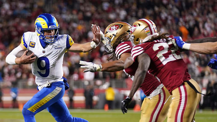 Dec 12, 2024; Santa Clara, California, USA; Los Angeles Rams quarterback Matthew Stafford (9) runs with the ball as San Francisco 49ers linebacker Fred Warner (54) defends in the fourth quarter at Levi's Stadium. Mandatory Credit: Cary Edmondson-Imagn Images