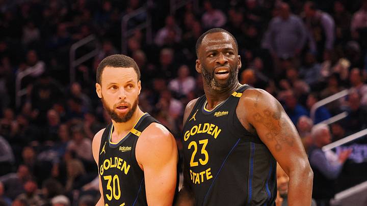 San Francisco, California, USA; Golden State Warriors guard Stephen Curry (30) and forward Draymond Green (23) look towards an Orlando Magic player at half time at Chase Center. Mandatory Credit: Kelley L Cox-Imagn Images