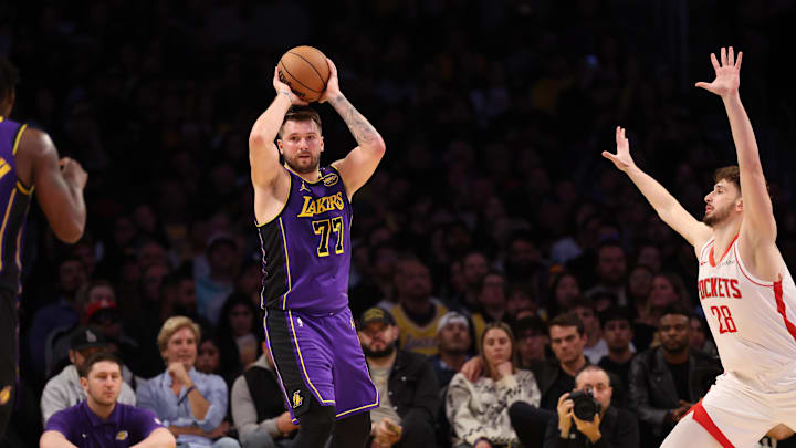 Mar 31, 2025; Los Angeles, California, USA; Los Angeles Lakers guard Luka Doncic (77) looks to pass as defends by Houston Rockets center Alperen Sengun (28) during the fourth quarter at Crypto.com Arena. Mandatory Credit: Kiyoshi Mio-Imagn Images Mar 31, 2025; Los Angeles, California, USA; Los Angeles Lakers guard Luka Doncic (77) looks to pass as defends by Houston Rockets center Alperen Sengun (28) during the fourth quarter at Crypto.com Arena. Mandatory Credit: Kiyoshi Mio-Imagn Images