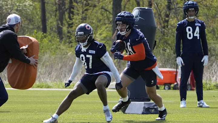 Luther Burden blocks while Colston Loveland (84) looks on the background.