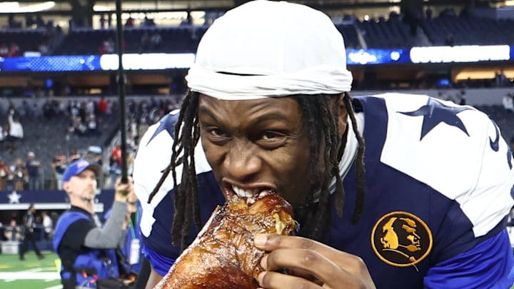 Nov 27, 2025; Arlington, Texas, USA; Dallas Cowboys wide receiver George Pickens (3) celebrates by eating turkey after the game against the Kansas City Chiefs at AT&T Stadium. Mandatory Credit: Kevin Jairaj-Imagn Images