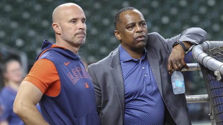 Houston Astros manager Joe Espada (left) and general manager Dana Brown (right) talk on the field before the game. 
