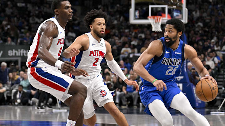 Mar 21, 2025; Dallas, Texas, USA; Dallas Mavericks guard Spencer Dinwiddie (26) moves the ball past Detroit Pistons center Jalen Duren (0) and guard Cade Cunningham (2) during the first quarter at the American Airlines Center. Mandatory Credit: Jerome Miron-Imagn Images