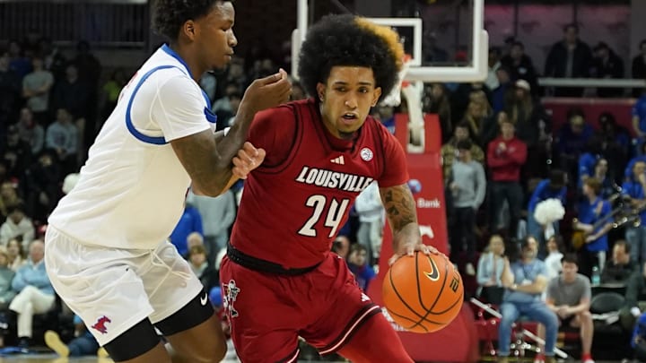 Jan 21, 2025; Dallas, Texas, USA; Louisville Cardinals guard Chucky Hepburn (24) dribbles past SMU Mustangs guard Chuck Harris (3) during the first half at Moody Coliseum. 
