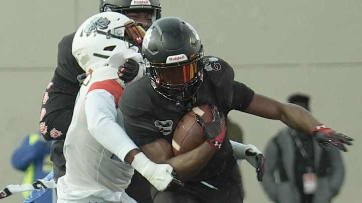 Team Roses' Christian Alexander (7) makes his way down the field with a defender trying to bring him down during the Under Armour All-America Game Saturday, Jan. 3, 2026 at Spec Martin Stadium in DeLand.