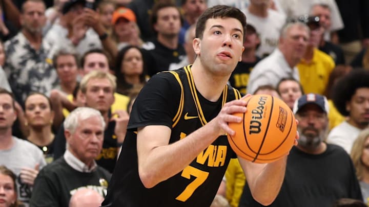 Iowa Hawkeyes forward Alvaro Folgueiras (7) makes a go-ahead three-point basket against the Florida Gators late in the second half during a second-round game of the 2026 NCAA Tournament at Benchmark International Arena in Tampa, Florida.