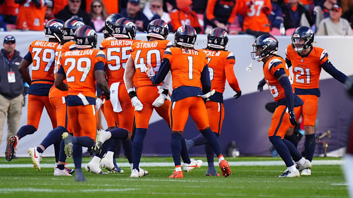 Nov 17, 2024; Denver, Colorado, USA; Members of the Denver Broncos defensive squad celebrate a turnover in the second half against the Atlanta Falcons at Empower Field at Mile High. 