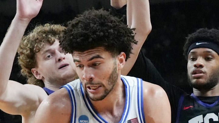 Duke Blue Devils forward Cameron Boozer (12) spins to score near TCU Horned Frogs forward David Punch (15) March 21, 2026 during the second half of the NCAA Men’s Basketball Tournament second round East Region game at the Bon Secours Wellness Arena in Greenville, South Carolina.