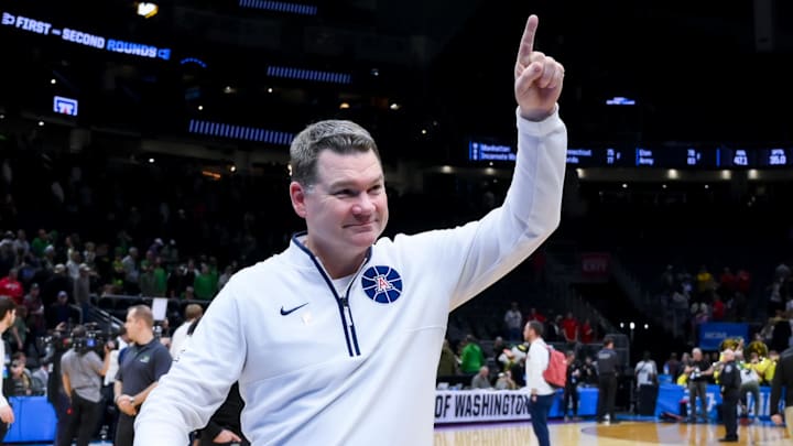 Mar 23, 2025; Seattle, WA, USA;  Arizona Wildcats head coach Tommy Lloyd celebrates after defeating the Oregon Ducks at Climate Pledge Arena. Mandatory Credit: Stephen Brashear-Imagn Images