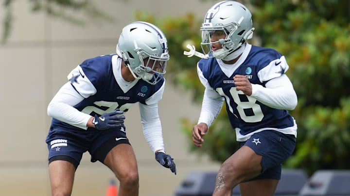 Dallas Cowboys cornerback Devin Moore and safety Caleb Downs go through a drill during practice.