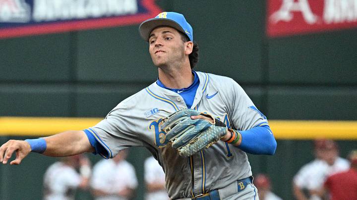Jun 17, 2025; Omaha, Neb, USA; UCLA Bruins shortstop Roch Cholowsky (1) completes a double play after getting Arkansas Razorbacks center fielder Justin Thomas Jr. (4) out during the fifth inning at Charles Schwab Field. Mandatory Credit: Steven Branscombe-Imagn Images Jun 17, 2025; Omaha, Neb, USA; UCLA Bruins shortstop Roch Cholowsky (1) completes a double play after getting Arkansas Razorbacks center fielder Justin Thomas Jr. (4) out during the fifth inning at Charles Schwab Field. Mandatory Credit: Steven Branscombe-Imagn Images