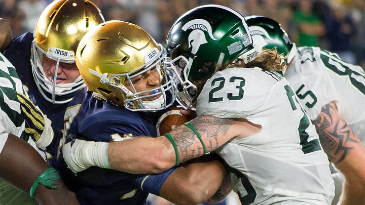 Sep 17, 2016; South Bend, IN, USA; Notre Dame Fighting Irish quarterback DeShone Kizer (14) fights his way into the end zone as Michigan State Spartans linebacker Chris Frey (23) defends in the fourth quarter at Notre Dame Stadium. MSU won 36-28. Mandatory Credit: Matt Cashore-USA TODAY Sports Sep 17, 2016; South Bend, IN, USA; Notre Dame Fighting Irish quarterback DeShone Kizer (14) fights his way into the end zone as Michigan State Spartans linebacker Chris Frey (23) defends in the fourth quarter at Notre Dame Stadium. MSU won 36-28. Mandatory Credit: Matt Cashore-USA TODAY Sports