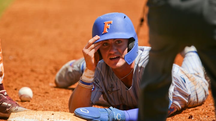 Florida base runner Jud Fabian (4) looks up to the umpire after being called safe.