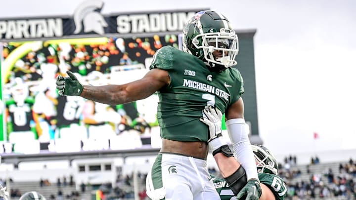 Michigan State's Jayden Reed, center, is hoisted by J.D. Duplain after Reed's touchdown catch against Rutgers during the third quarter on Saturday, Nov. 12, 2022, in East Lansing.

221112 Msu Rutgers Fb 151a